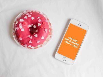 Pink donut next to silver iPhone mockup